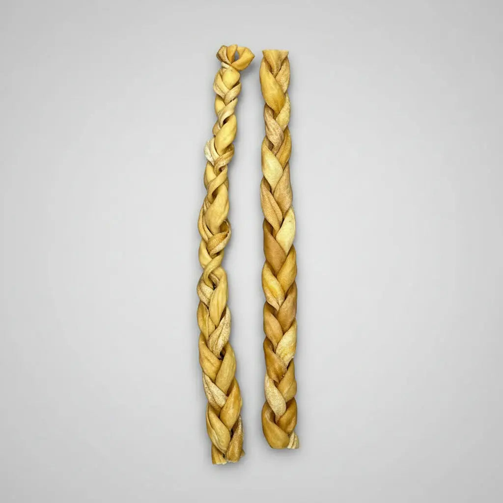 Two braided lambs on a grey background, likely used for pet treat supplies.